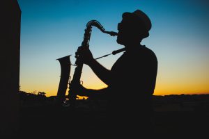 Silhouette of a Man Playing Saxophone tomer levi the option to be musician during Sunset